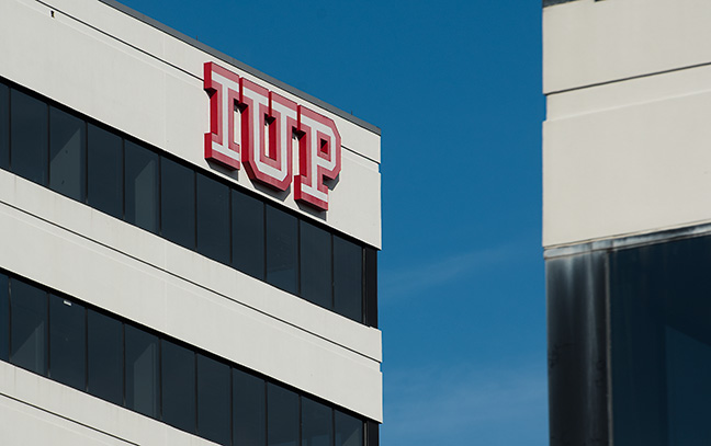 A tall, white building with an IUP logo at the top.