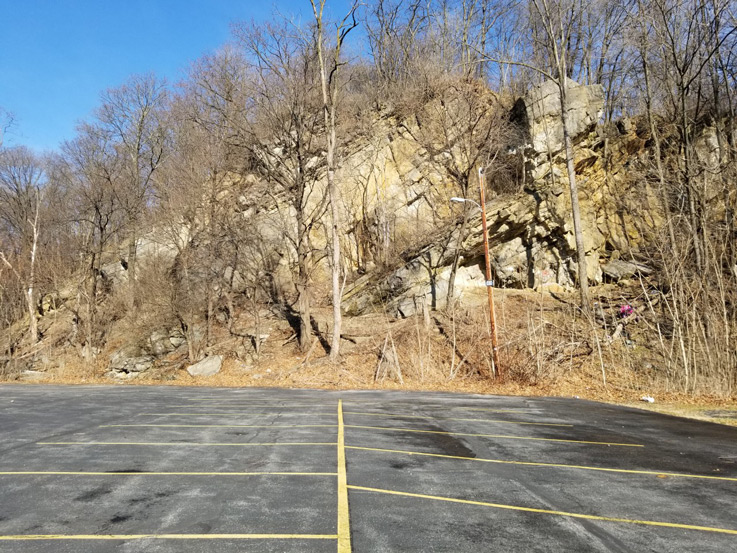a hillside next to a parking lot