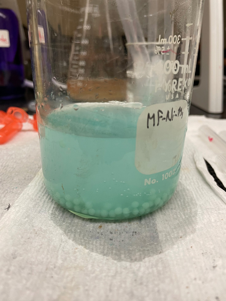 light blue liquid in a glass container