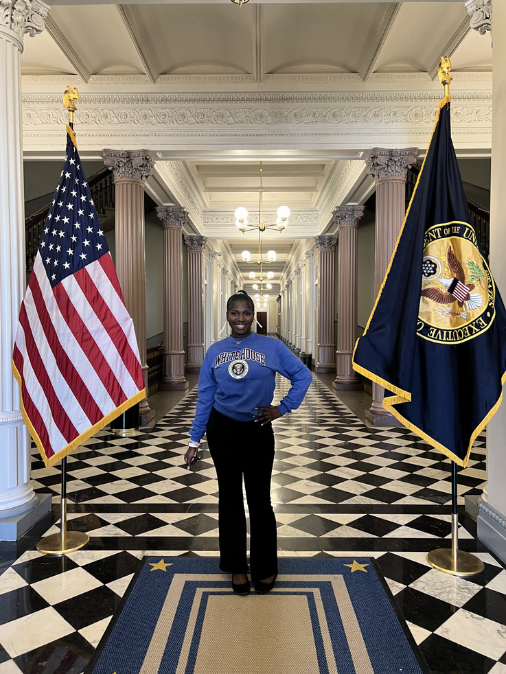 Kiyana Tucker smiling in a hallway at the White House