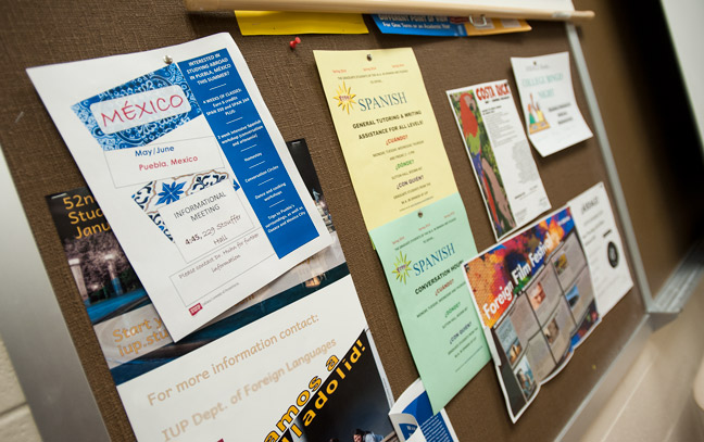display board of flyers advertising spanish opportunities on campus and related to classes