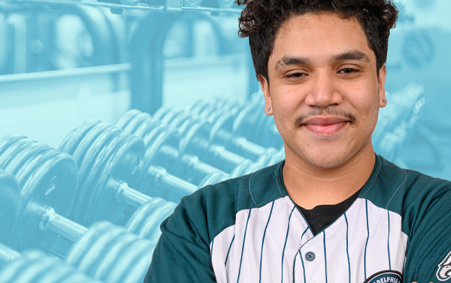 a student wearing an athletic team shirt superimposed in front of a teal background showing rows of weights on a rack in a gym