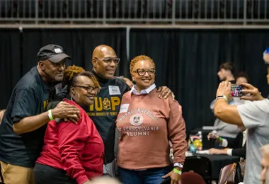 a group of 4 alumni posing for a photo