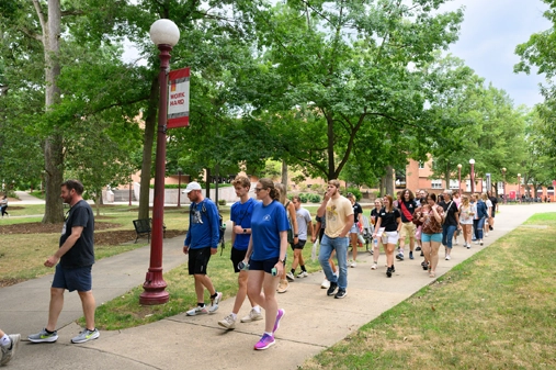 students walking through the oak grove
