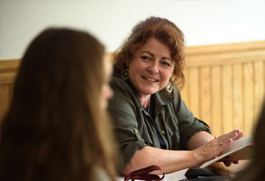 a professor talking to students in a classroom