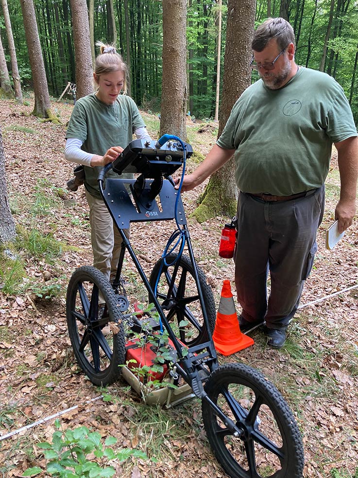 Dr. Chadwick and student conduct GPR survey.