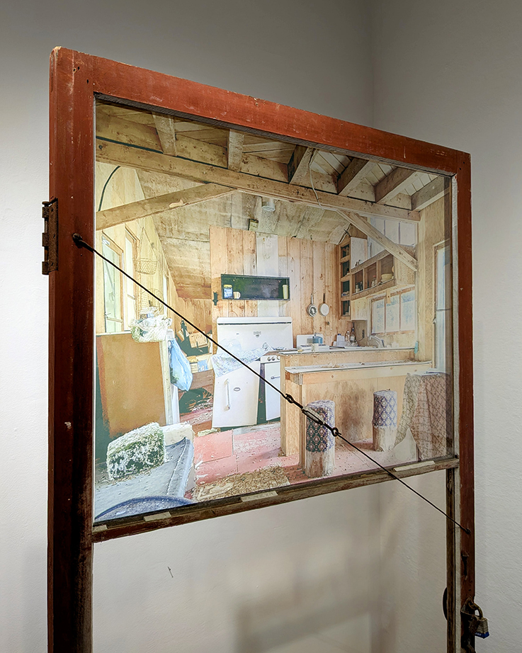 Front door of the cabin with a photo of the interior before deconstruction