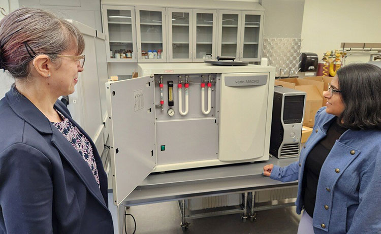 Andrada Maicaneanu and Avijita Jain, Madia Department of Chemistry, Biochemistry, and Physics, with an instrument donated by Concurrent Technologies Corporation