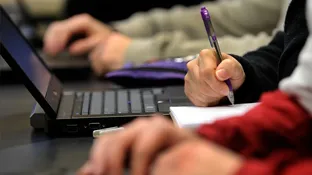 a close up of a person working on a laptop