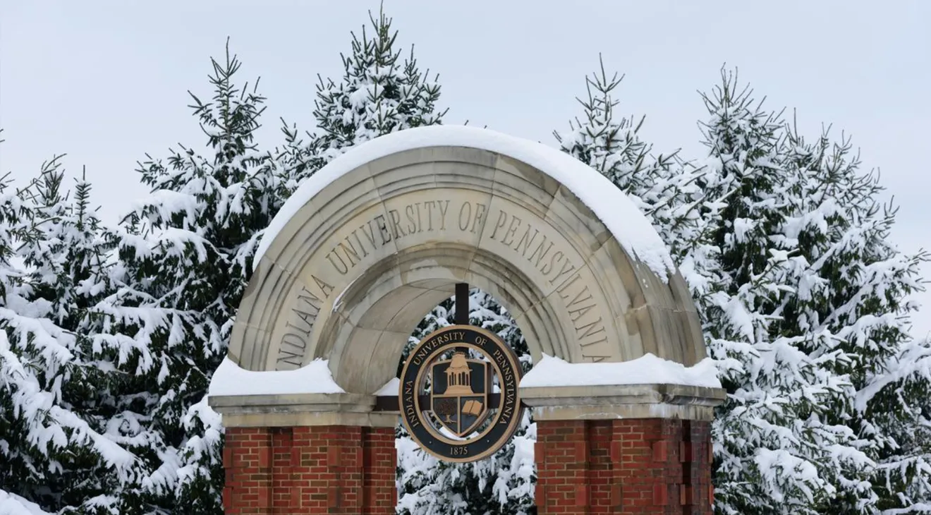 A snow covered IUP entry arch