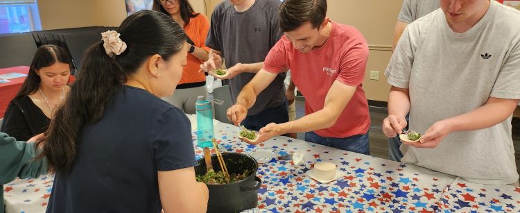 Chinese Program Participants learning Chinese cooking techniques