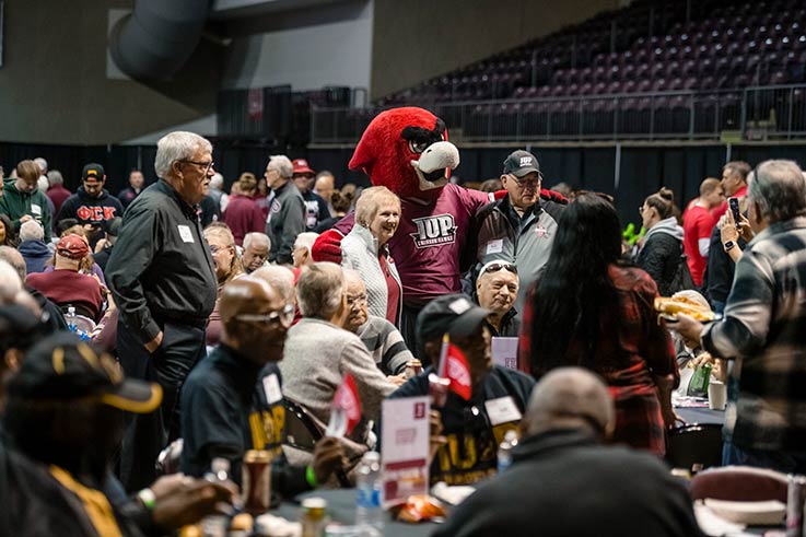 large group of alumni gathered in the kcac during the crimson huddle