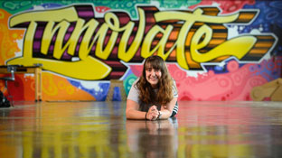 female student posing in front of a colorful background