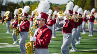 students in the iup marching band perform on the field