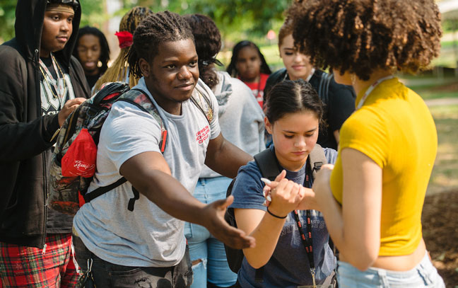 A group of students in the oak grove