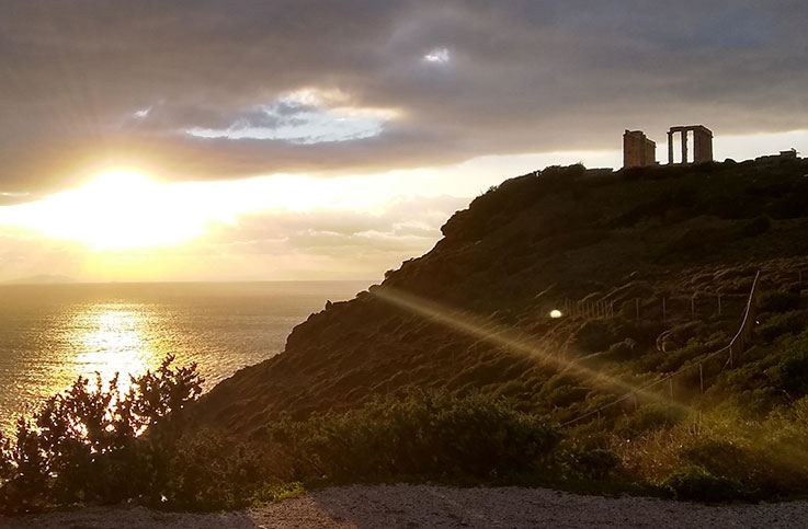 Poseidon's Temple in Greece with sunset over the sea in the background