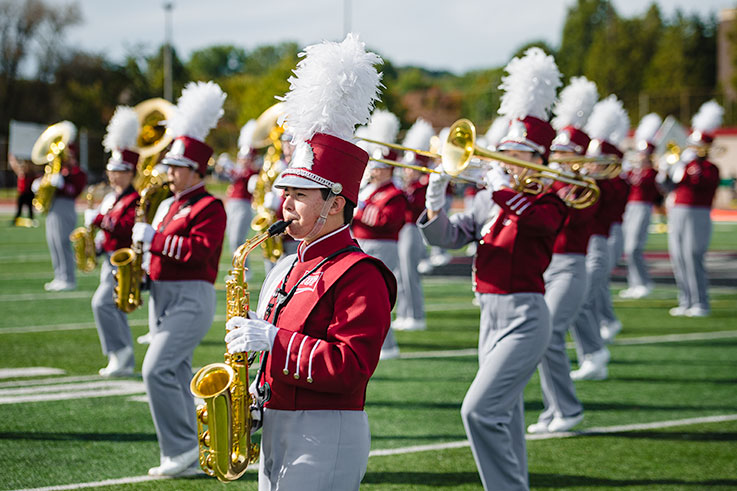 IUP Marching Band playing on the football field during a football game