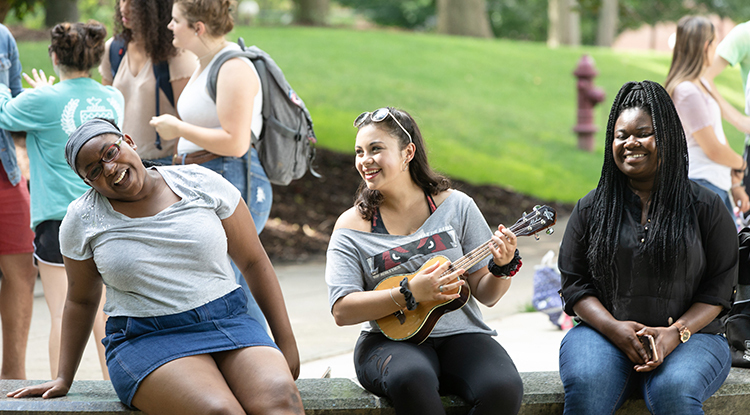 students sitting together in the oak grove