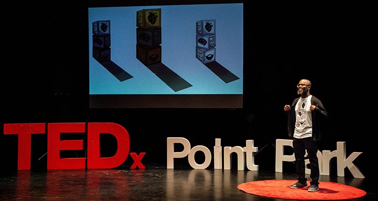 Donovan Daniel speaking on the TEDx Talk stage in Point Park