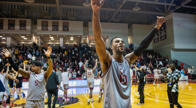 the IUP men's basketball team waving to the crowd from the court