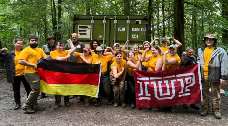 Students in a group photo holding German and IUP flags