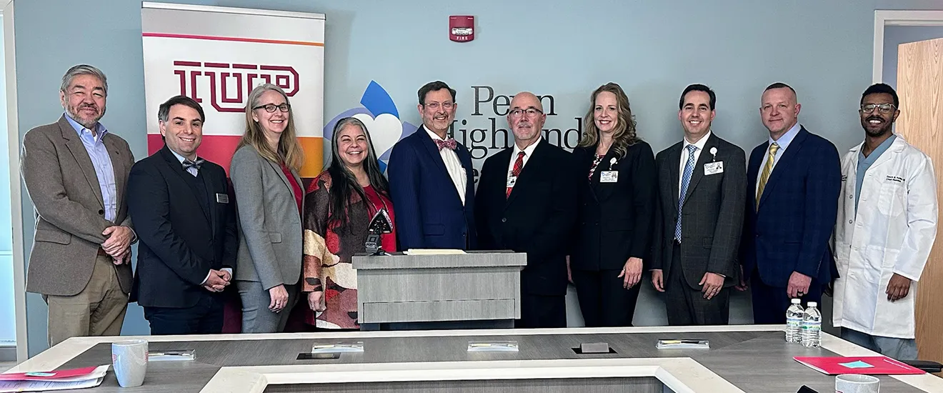 a group standing in front of a podium smiling