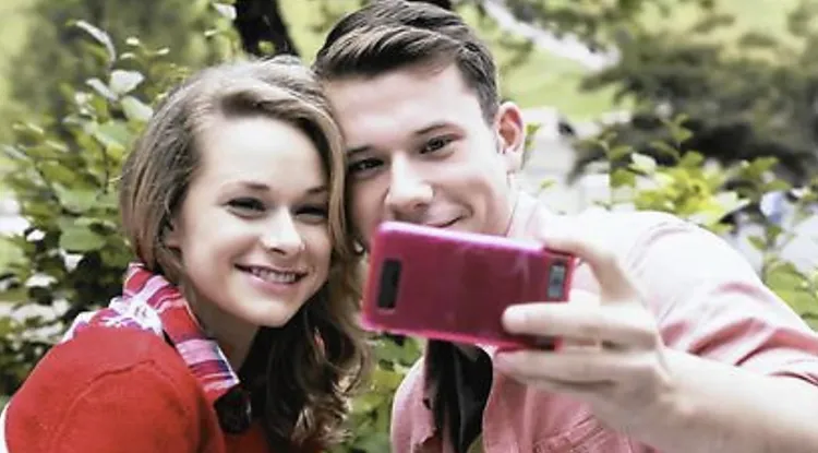 Movie still of a young couple taking a selfie