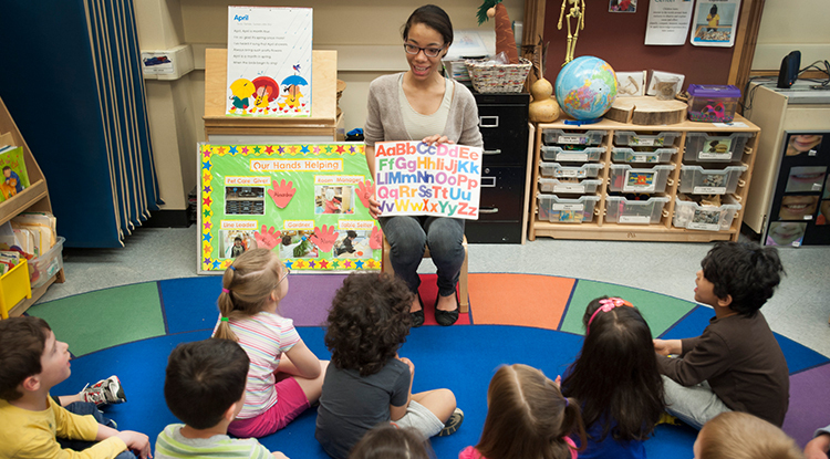 A teacher addressing a group of young students