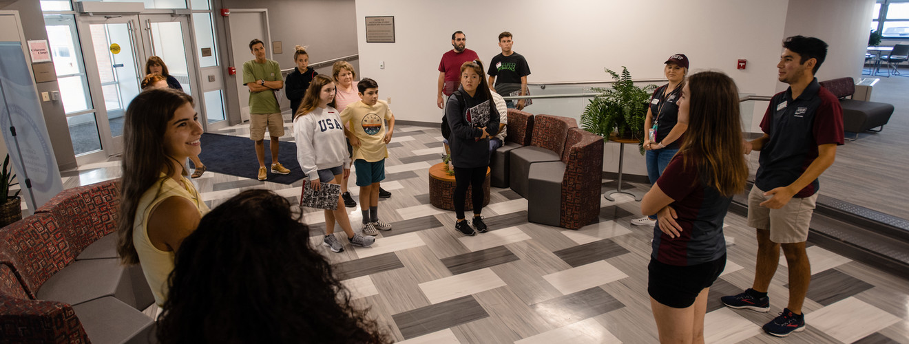 students standing in a lobby and talking
