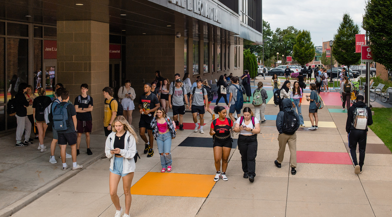 students walking on a sidewalk