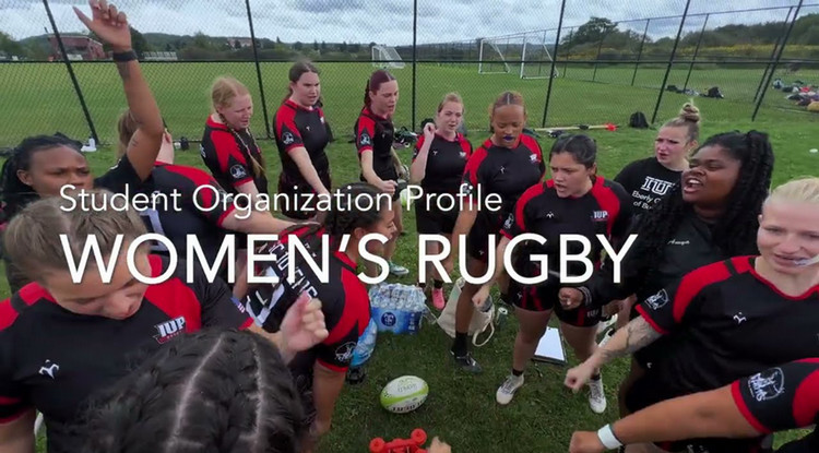 A group of women rugby players in a huddle