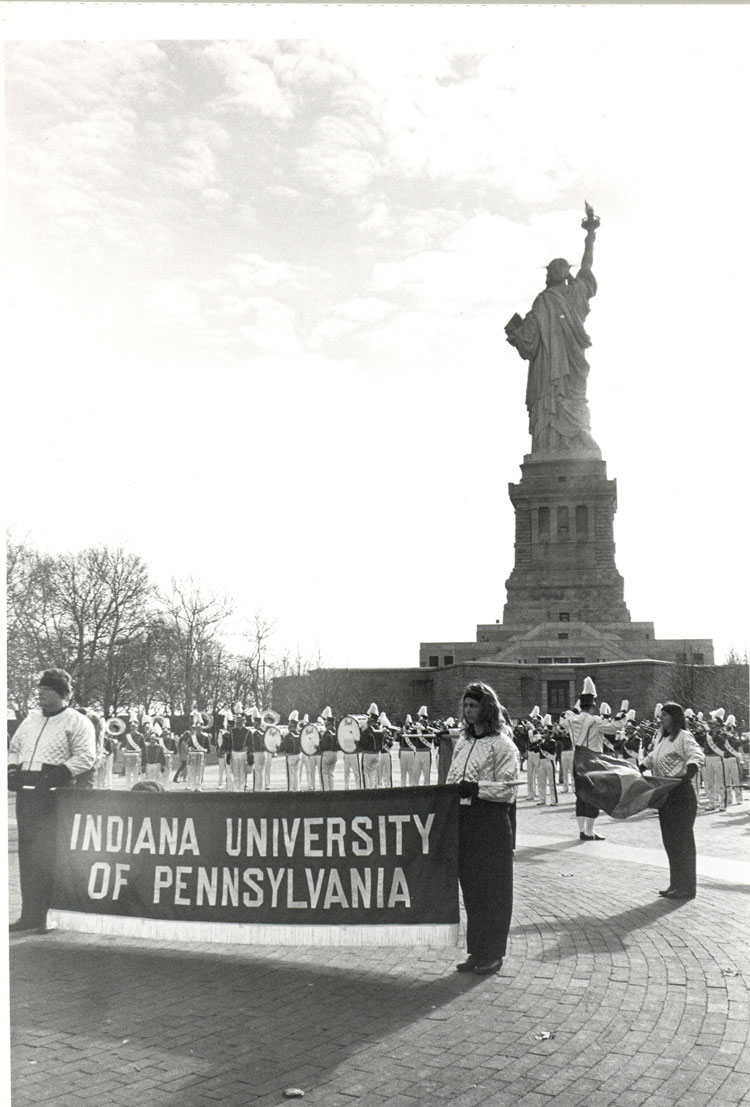 marching band members holding a banner, 1984