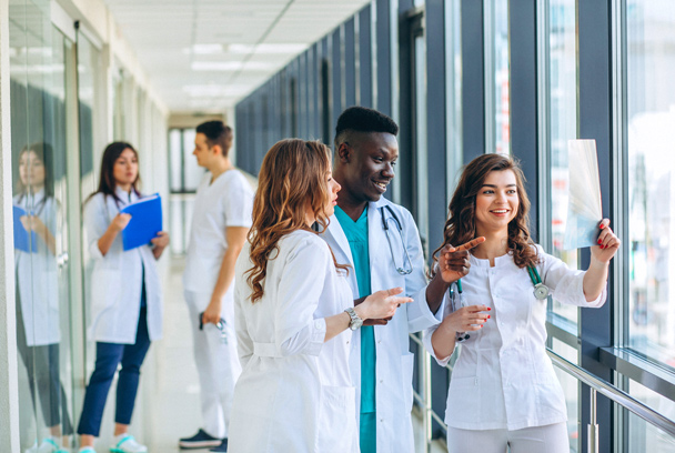 doctors and nurses talking in a hospital hallway