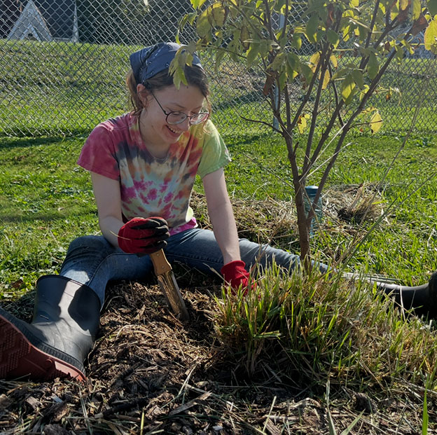 An IUP student serving at the Indiana Community Garden during Into the Streets - Fall 2024