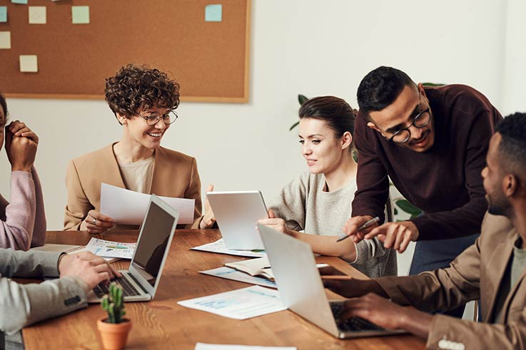 Six people at a table working together.