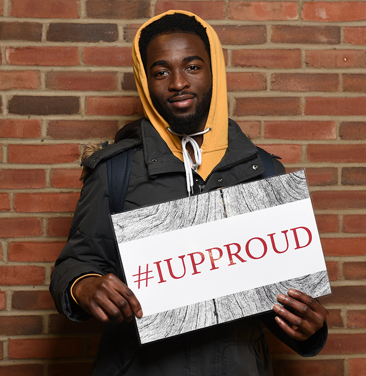 IUP student holding Thank a Donor sign 