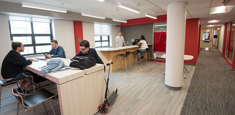 Students meeting in the shared work space 